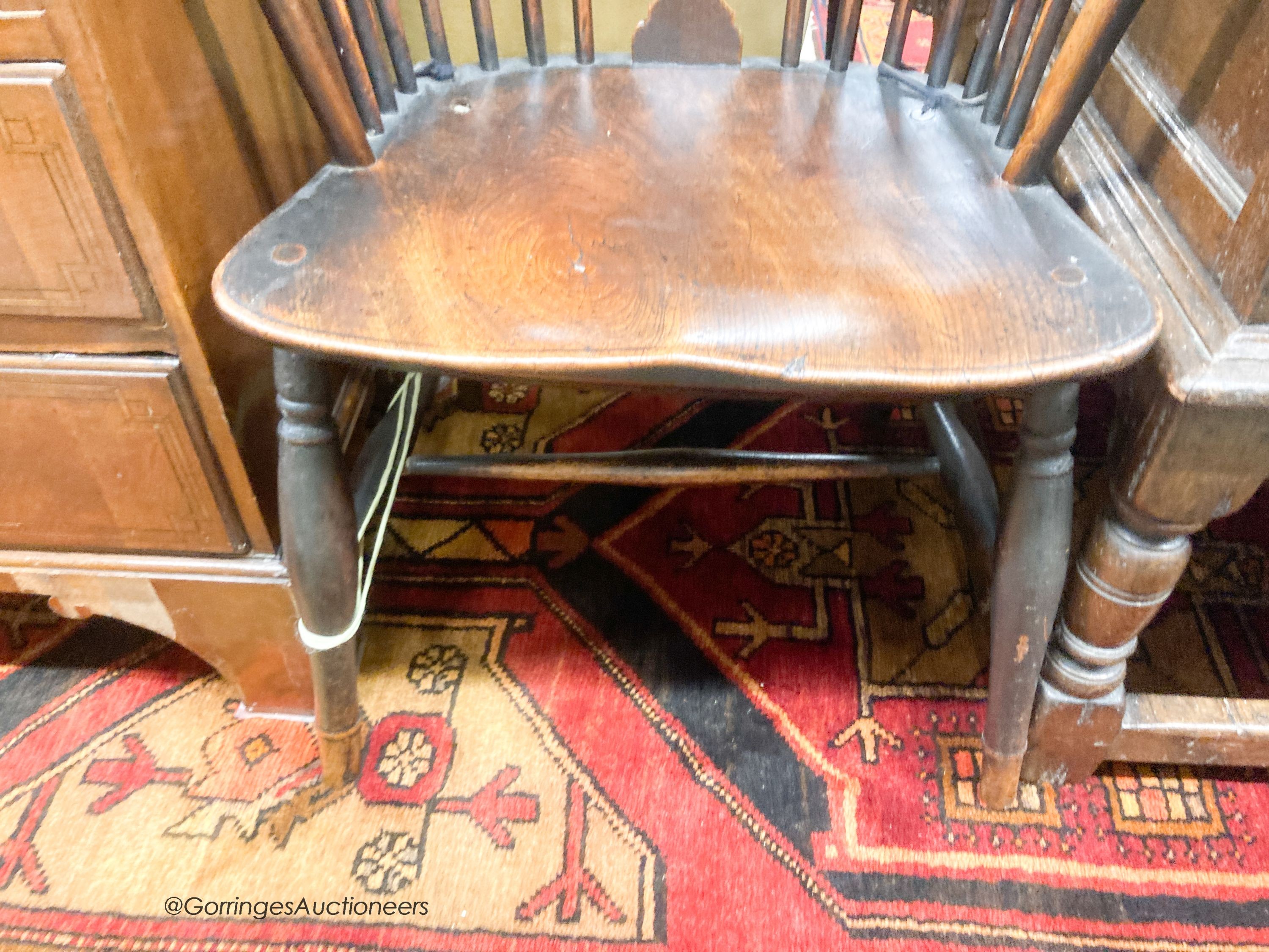 An early 19th century elm and ash wheel back elbow chair, width 52cm, depth 42cm, height 102cm